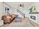 Comfortable living room featuring a fireplace, TV, and staircase to the upper level at 21 N Edge Cliff St, Castle Rock, CO 80104