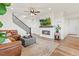 Bright living room with fireplace, staircase, and cozy seating arrangement at 21 N Edge Cliff St, Castle Rock, CO 80104