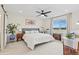 Bright bedroom with white carpet, a cozy bed, and large windows offering pleasant views at 21 N Edge Cliff St, Castle Rock, CO 80104