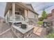 Inviting backyard with a stone fire pit and a built-in grill, perfect for entertaining at 8153 S Ider Ct, Aurora, CO 80016