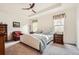A cozy bedroom with a tray ceiling, ceiling fan, and large windows with natural light at 8153 S Ider Ct, Aurora, CO 80016