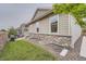 Exterior view of a home with a stone foundation, lush lawn, and outdoor grill at 8153 S Ider Ct, Aurora, CO 80016