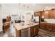Spacious kitchen with island, granite countertops, stainless steel appliances, and wood floors throughout at 8153 S Ider Ct, Aurora, CO 80016