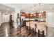 Spacious kitchen featuring stainless steel appliances, a center island with seating, and hardwood floors at 8153 S Ider Ct, Aurora, CO 80016