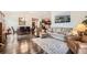 Inviting living room and dining area with hardwood floors, stylish furnishings, and a seamless flow for entertaining guests at 8153 S Ider Ct, Aurora, CO 80016
