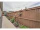 Charming side yard with wooden fence, flowers, and greenery, enhancing privacy and appeal at 8153 S Ider Ct, Aurora, CO 80016