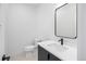 Modern half bathroom with contemporary finishes, black fixtures and vanity at 1252 Yates St, Denver, CO 80204