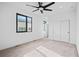 Well-lit carpeted bedroom with large window, white walls, modern ceiling fan, and large closet at 1252 Yates St, Denver, CO 80204