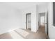 Bright bedroom featuring neutral carpet, large closet with sliding doors and a doorway to the bathroom at 1252 Yates St, Denver, CO 80204