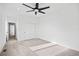 Spacious bedroom with modern ceiling fan, carpet, white walls, and a sliding door closet at 1252 Yates St, Denver, CO 80204