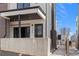 Modern townhome entrance featuring black accents, a brick facade, and a stylish covered porch at 1252 Yates St, Denver, CO 80204