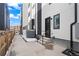 Modern townhome entrance featuring a black front door, sleek design, and a well-maintained walkway at 1252 Yates St, Denver, CO 80204