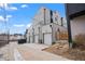 Contemporary townhome exterior with private garages, modern design, and convenient alley access, offers urban living at 1252 Yates St, Denver, CO 80204