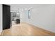 Bright, open kitchen with black cabinets, a center island, hardwood floors, and modern pendant lighting at 1252 Yates St, Denver, CO 80204