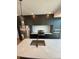 Modern kitchen with dark cabinetry, quartz counters, and stainless steel appliances at 1252 Yates St, Denver, CO 80204