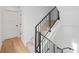 Modern staircase with carpet runner and black metal railing at 1252 Yates St, Denver, CO 80204