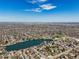 Wide aerial shot of a neighborhood with lakes and a distant city skyline at 2562 S Xavier St, Denver, CO 80219