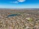 Vast aerial view showcasing a residential area with a lake and city skyline in the distance at 2562 S Xavier St, Denver, CO 80219