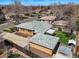 Aerial view of a single-Gathering home with a spacious yard, garage, and fencing at 2562 S Xavier St, Denver, CO 80219