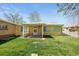 The back of the home includes a cozy patio and plenty of green space at 2562 S Xavier St, Denver, CO 80219