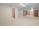 Spacious basement features neutral carpet and multiple access doors at 2562 S Xavier St, Denver, CO 80219