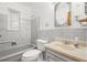 Bathroom with tub and tiled walls, sink and vanity with large mirror, and natural light at 2562 S Xavier St, Denver, CO 80219