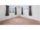 Bright bedroom with two large windows, neutral paint, and cozy wall to wall carpeting at 2562 S Xavier St, Denver, CO 80219