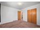 Clean bedroom with neutral carpet, closet, and bright natural light at 2562 S Xavier St, Denver, CO 80219