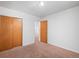 Bedroom with neutral carpet, closet, and bright natural light at 2562 S Xavier St, Denver, CO 80219