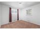Well-lit bedroom with a large window, neutral color, and carpet at 2562 S Xavier St, Denver, CO 80219