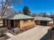 Charming brick home with an inviting front porch and well-maintained landscaping at 2562 S Xavier St, Denver, CO 80219