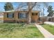 Well-maintained front yard with a brick house and manicured landscaping at 2562 S Xavier St, Denver, CO 80219