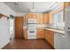 Cozy kitchen features wood-look floors, ample cabinetry, and white appliances at 2562 S Xavier St, Denver, CO 80219