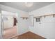 View from an adjacent room into a compact area with light wood cabinets and open shelves at 2562 S Xavier St, Denver, CO 80219