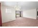 Bright living room boasts a classic chandelier and large windows for ample natural light at 2562 S Xavier St, Denver, CO 80219