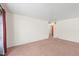 Empty living room showcases beige carpet and light walls at 2562 S Xavier St, Denver, CO 80219
