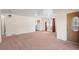 Open living area showcases the front door, chandelier, and an adjacent room with white appliances at 2562 S Xavier St, Denver, CO 80219