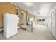 Bright sunroom features a refrigerator, laundry area, and access to the backyard at 2562 S Xavier St, Denver, CO 80219