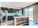 Modern kitchen with island, stainless steel appliances, and backyard access at 4765 S Netherland St, Centennial, CO 80015