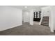 Finished basement with new carpet, white walls, and built-in shelving at 17486 E Plateau Dr, Aurora, CO 80015