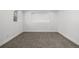 Finished basement with neutral carpet, white walls, and a window at 17486 E Plateau Dr, Aurora, CO 80015