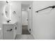 Bright bathroom features a sleek vanity, backlit mirror, and easy access to doorway at 17486 E Plateau Dr, Aurora, CO 80015