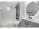 Modern bathroom featuring white tile, updated fixtures, and a sleek vanity at 17486 E Plateau Dr, Aurora, CO 80015