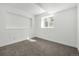 Minimalist bedroom features a well-lit space with a window and carpet flooring at 17486 E Plateau Dr, Aurora, CO 80015