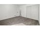 Bedroom with closet and a door showing hallway with white walls and neutral carpet at 17486 E Plateau Dr, Aurora, CO 80015