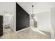 Dining area with hardwood floors and sliding glass doors next to a black accent wall at 17486 E Plateau Dr, Aurora, CO 80015