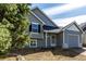 Charming gray two-story home featuring a well-maintained yard and attached garage at 17486 E Plateau Dr, Aurora, CO 80015