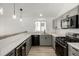 Modern kitchen with stainless steel appliances, gray cabinets, and quartz countertops at 17486 E Plateau Dr, Aurora, CO 80015