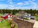 Expansive aerial view showing the home, surrounding acreage, and a large red barn at 37625 Pheasant Run, Elizabeth, CO 80107