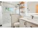 Modern bathroom featuring a walk-in shower, floating shelves, and vanity with LED mirror at 37625 Pheasant Run, Elizabeth, CO 80107